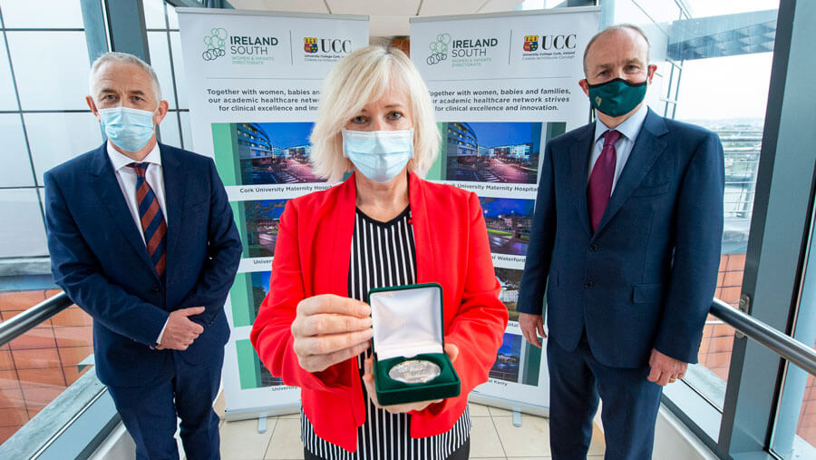 An Taoiseach, Micheál Martin presented Niamh Spillane, Clinical Midwifery Manager at CUMH  with her Covid-19 commemorative medal.  Also in the picture is Professor John R. Higgins.   Picture by Gerard McCarthy